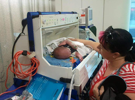 Young Abigail in hospital with mum