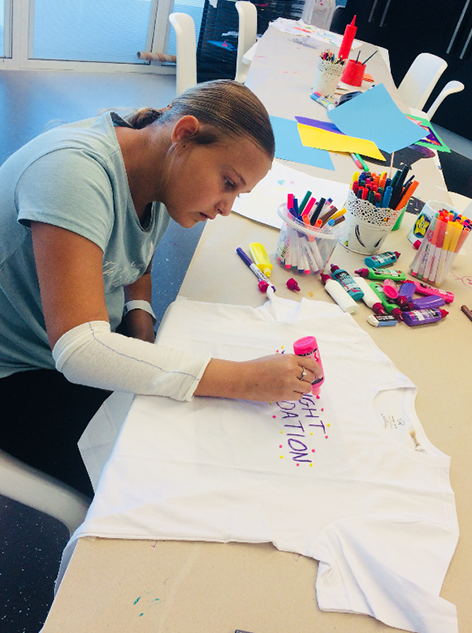Tegan designing t-shirt in the Starlight Express Room