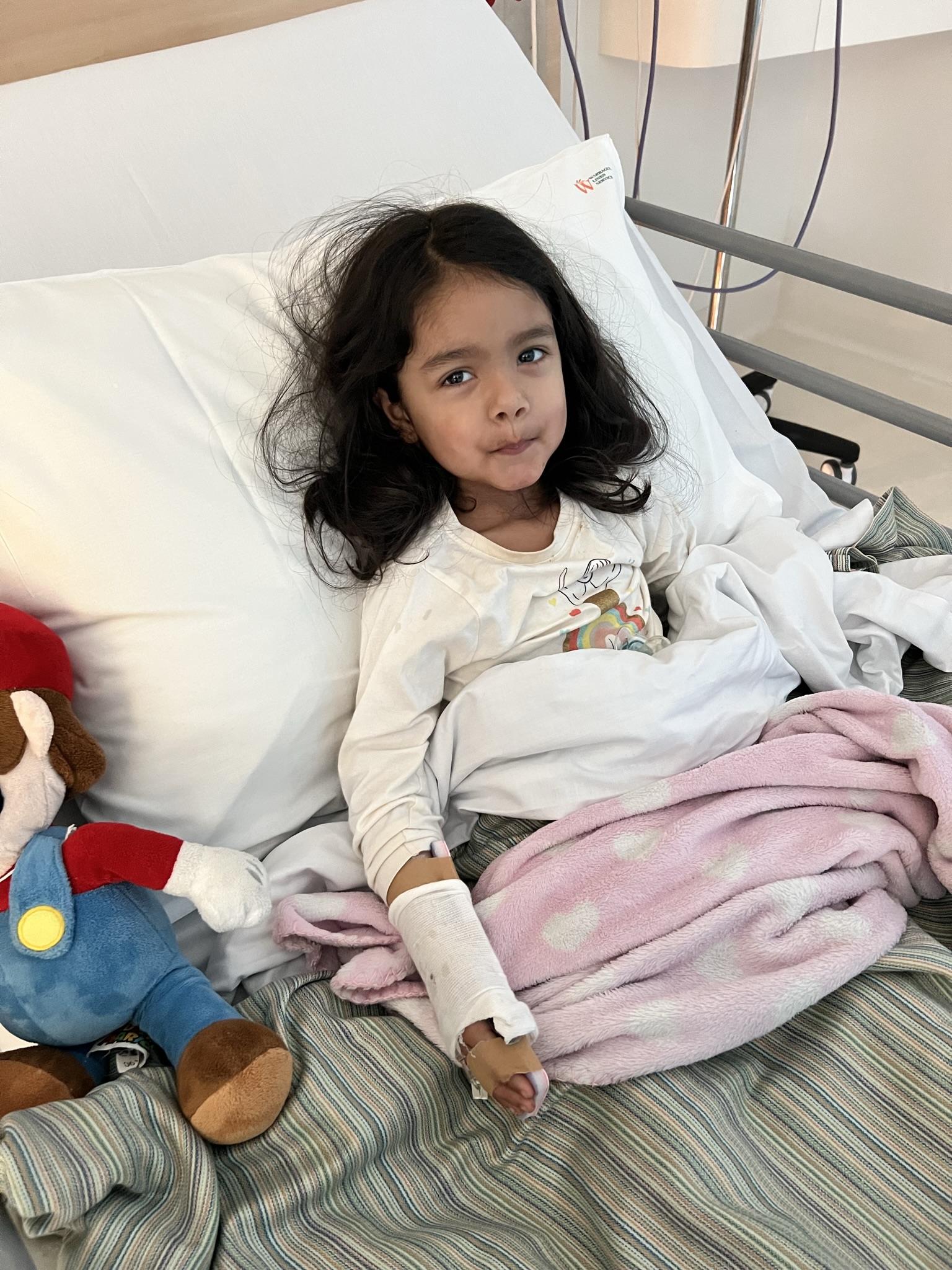 Priya in hospital bed