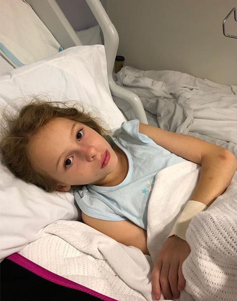 Rose lying in hospital bed