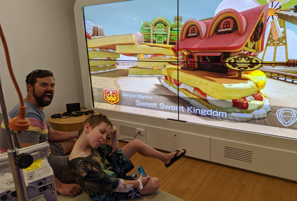 Rohan and dad playing video games in the Starlight Express Room