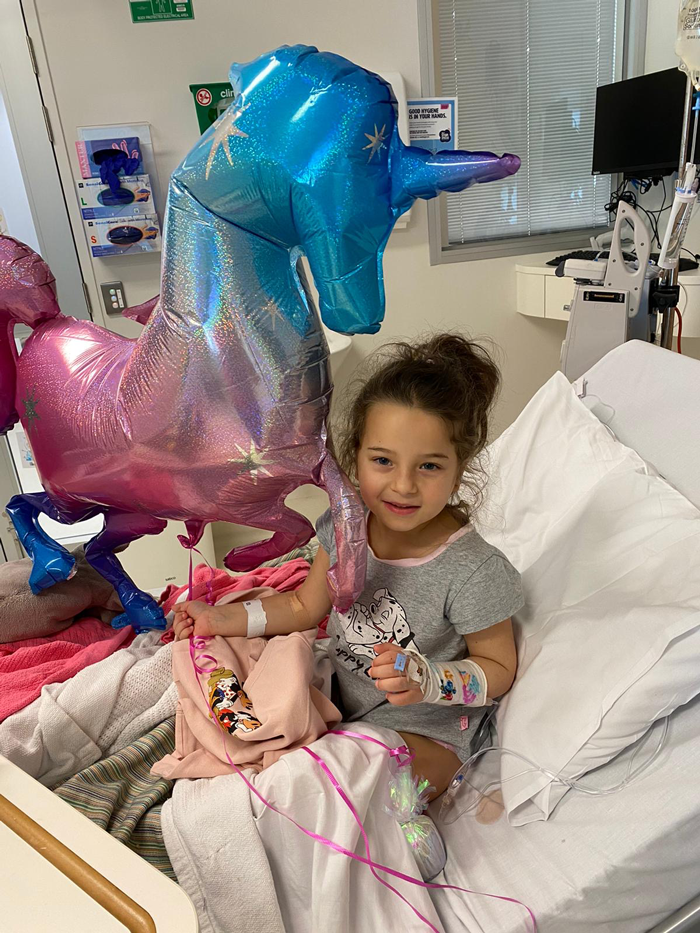 Isla in hospital with balloons