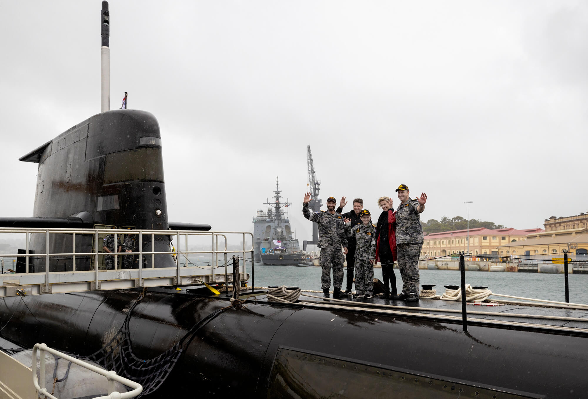 Ben with his family on the casing of HMAS Farncomb