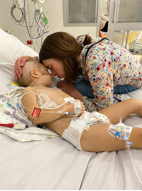 Chloe in hospital bed with her mum