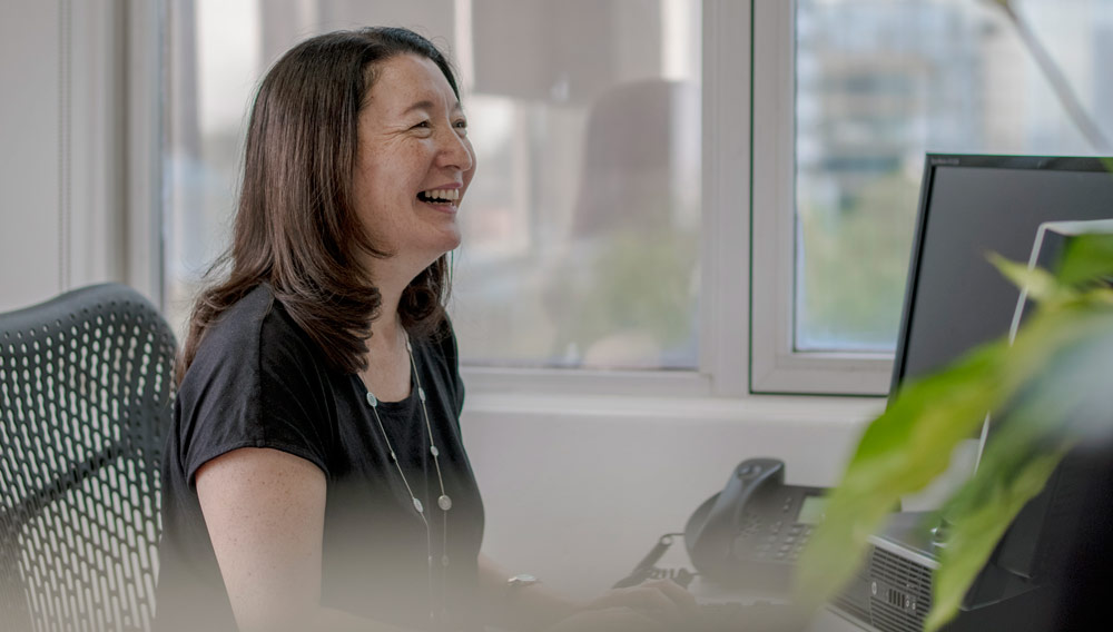 Starlight team member smiling at desk