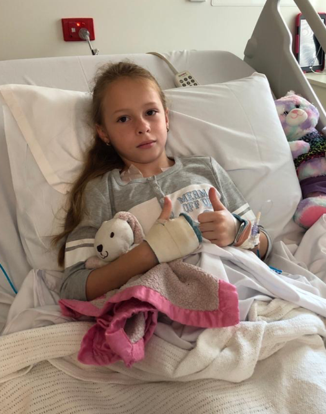 Rose thumbs up in hospital bed
