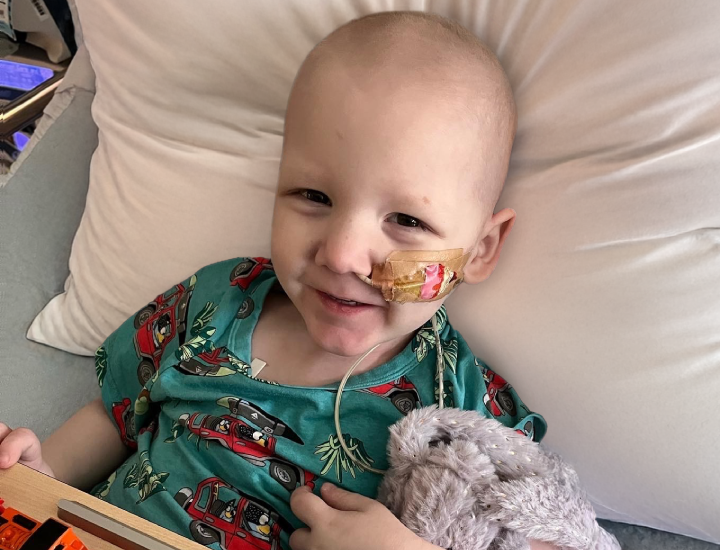 Liam in hospital bed smiling