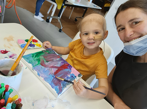 Chloe painting in the Starlight Express Room with her mum