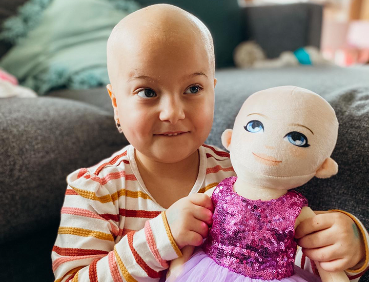 Isla holding doll
