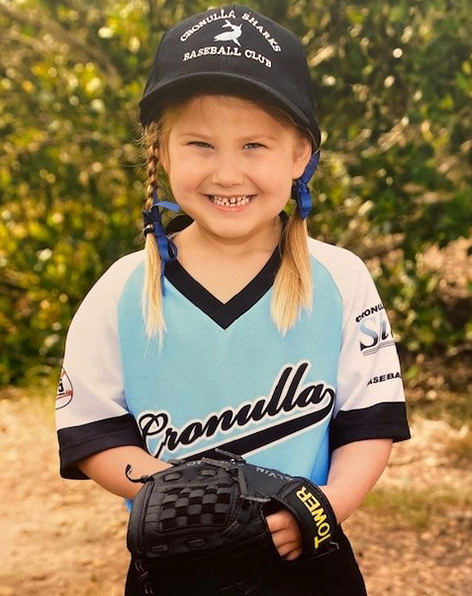 Amelia in softball uniform