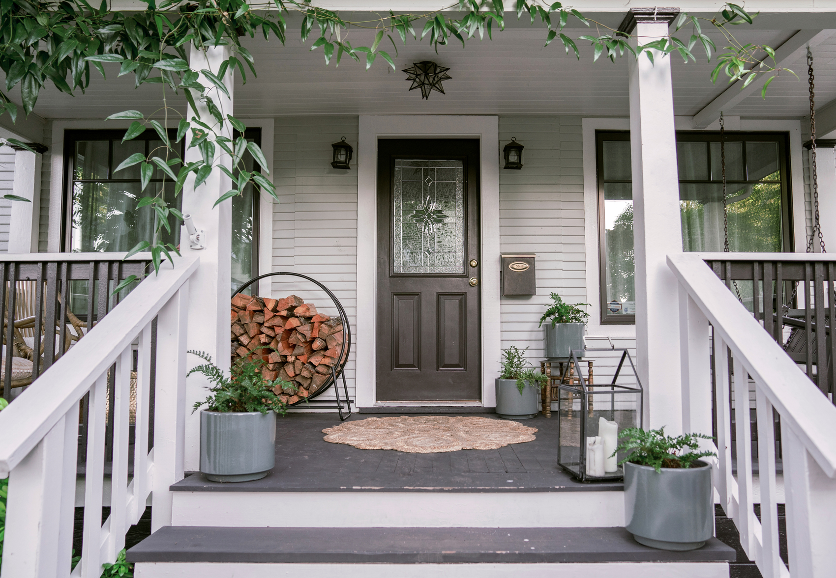 A front porch beautifully decorated with green ivy for spring 