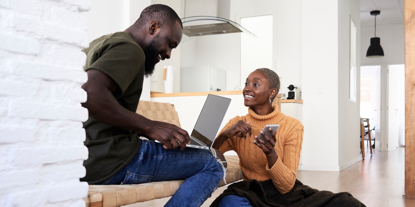 Two people use technology to renew a lease for a modern apartment