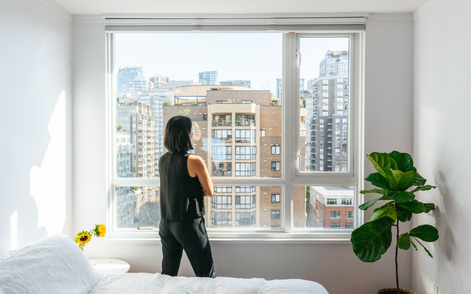 Image - Apartment tour photo of renter looking out the window in a bedroom
