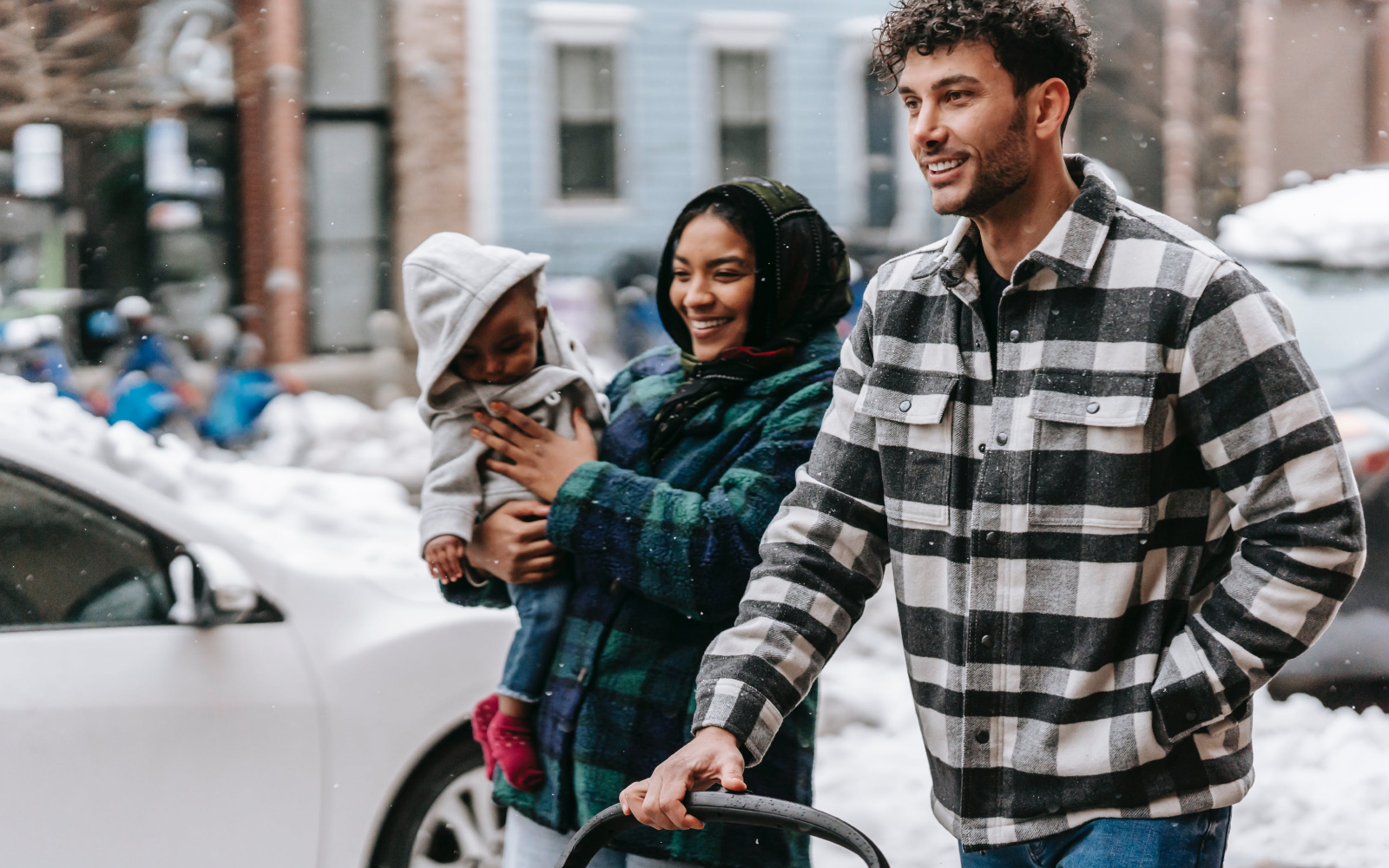 Image of renters walking with their family in their new neighborhood in winter.