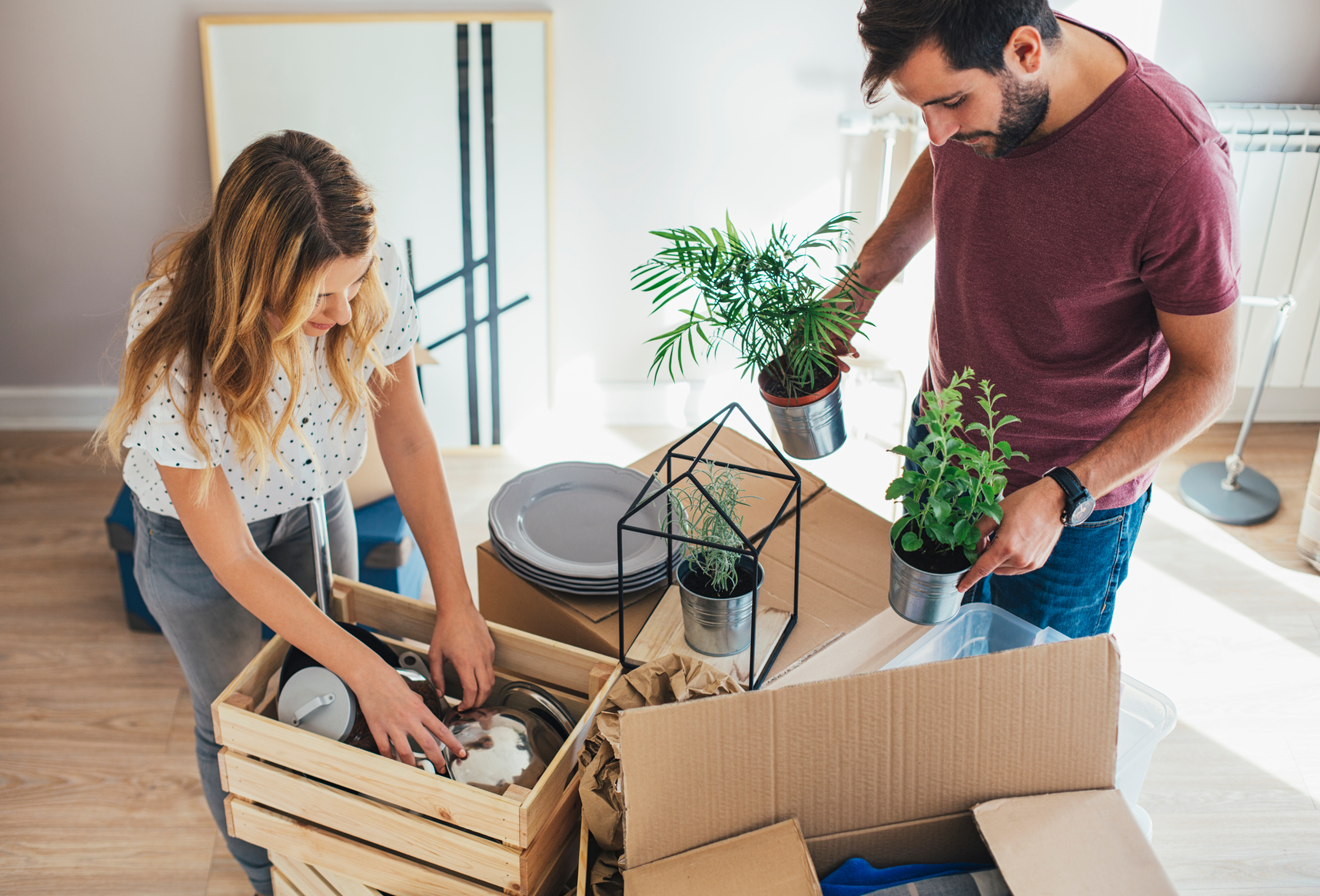 A couple moving into an apartment together and looking at their stuff, trying to figure how how much renters insurance they need 