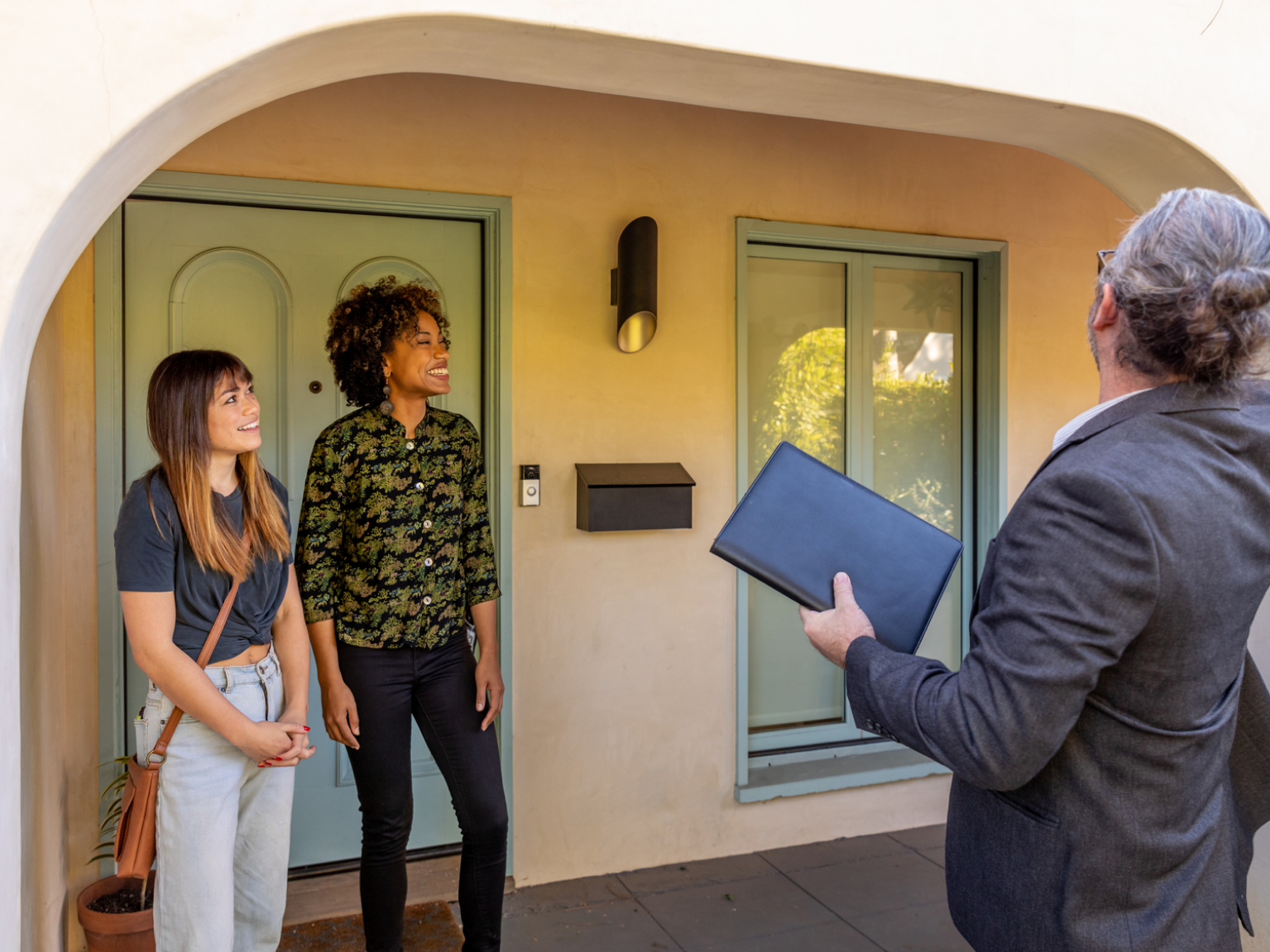 Image of renters meeting with a property manager to rent a single family home