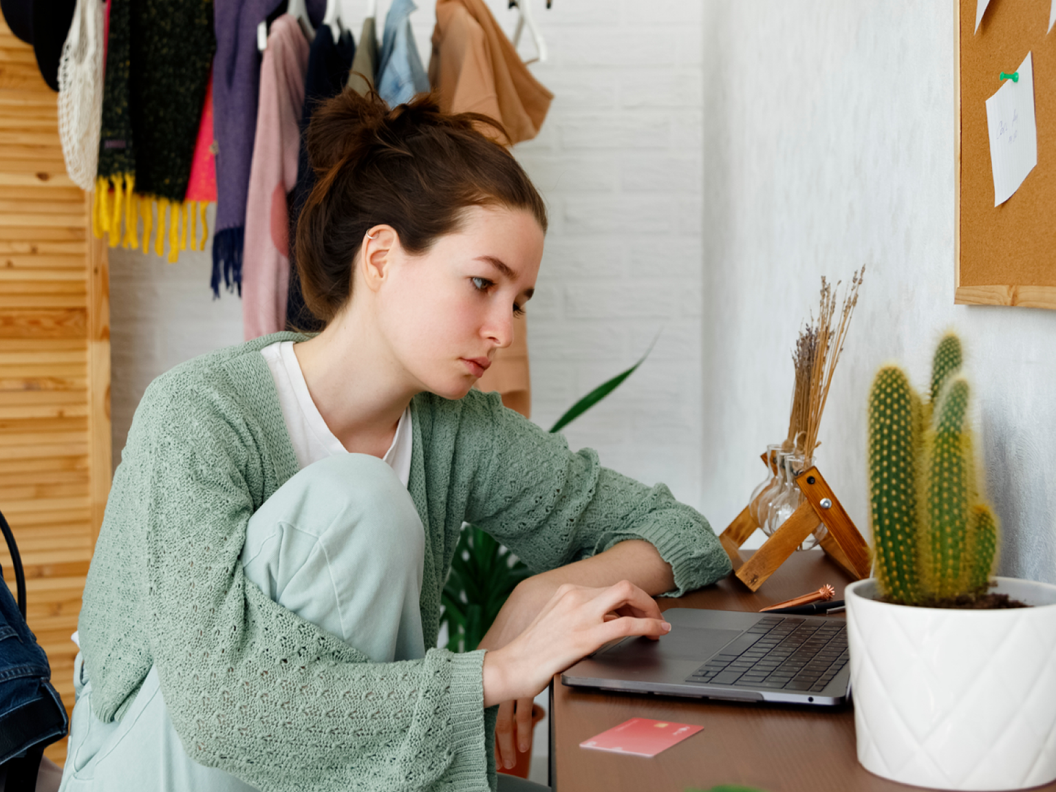 Image of a renter sitting at home with their credit card to pay rent.