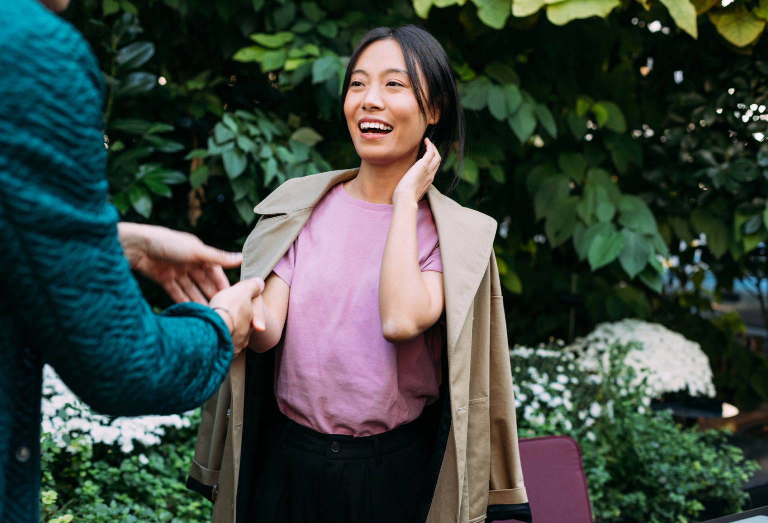 Image of a renter shaking hands with a landlord outside