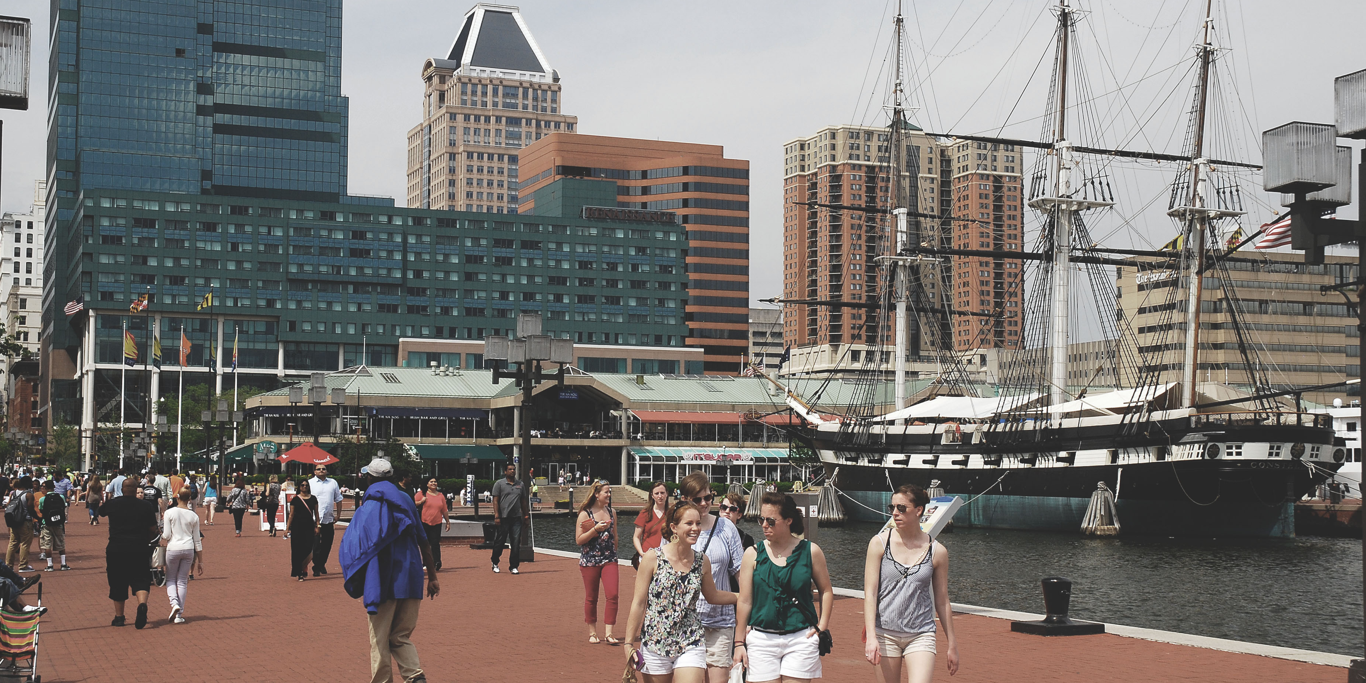 Hero image of Baltimore and the inner harbor neighborhood including a sailboat