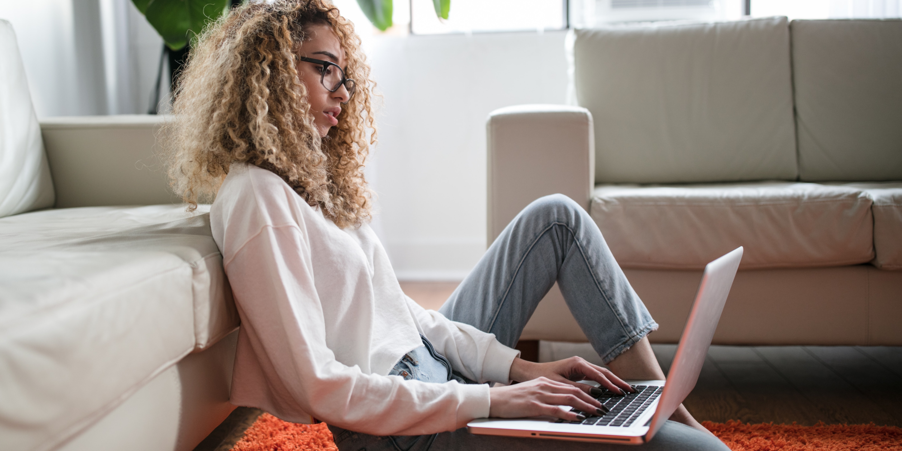 Rhino renter sitting on the floor using a laptop