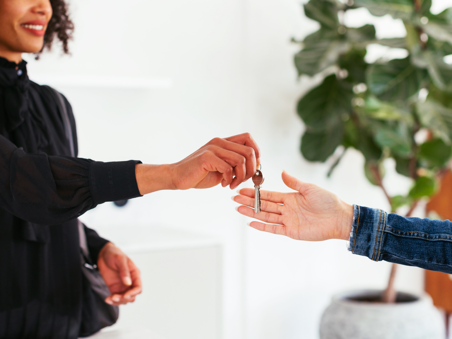 Image of a renter and landlord exchanging keys