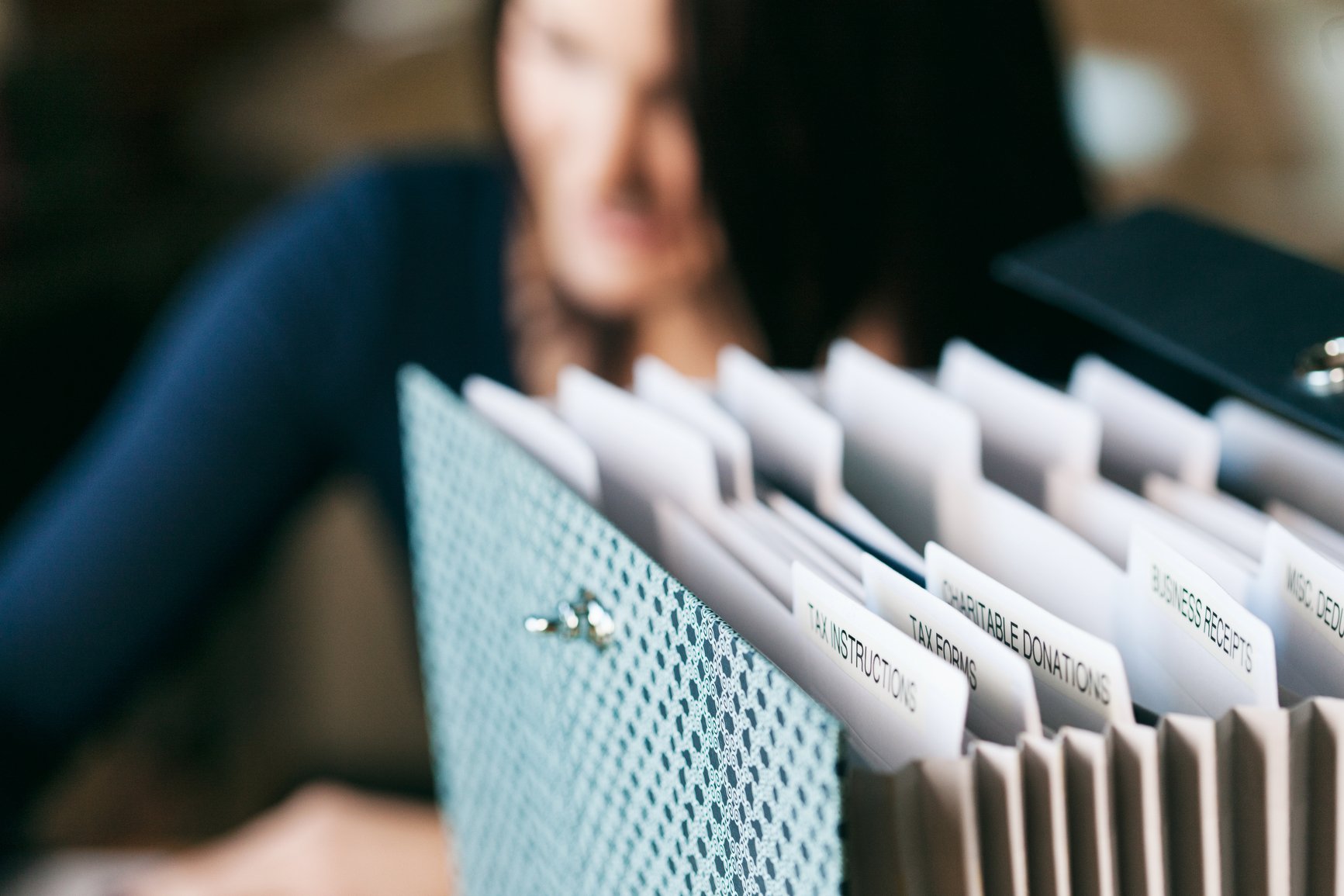 An image of a file folder will different sections for tax forms including "business receipts" and "instructions" 