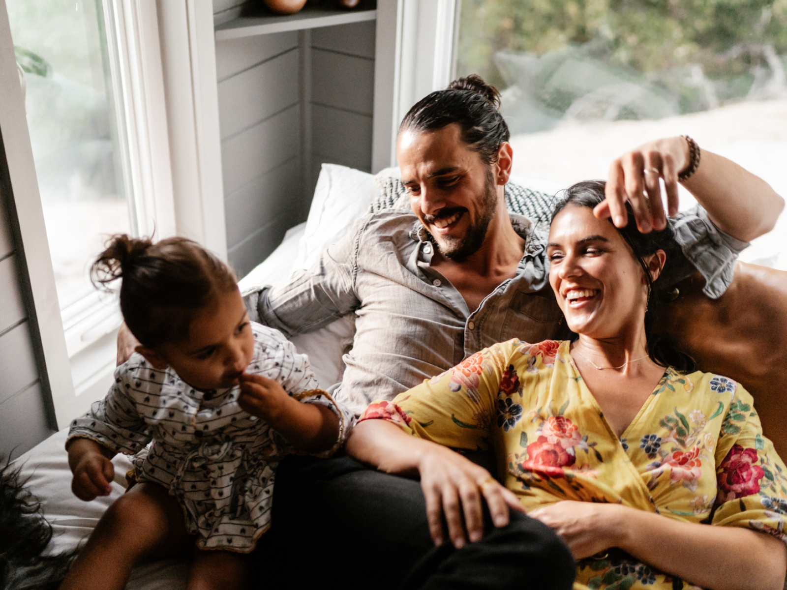 Image of a family happily laying in their rented home