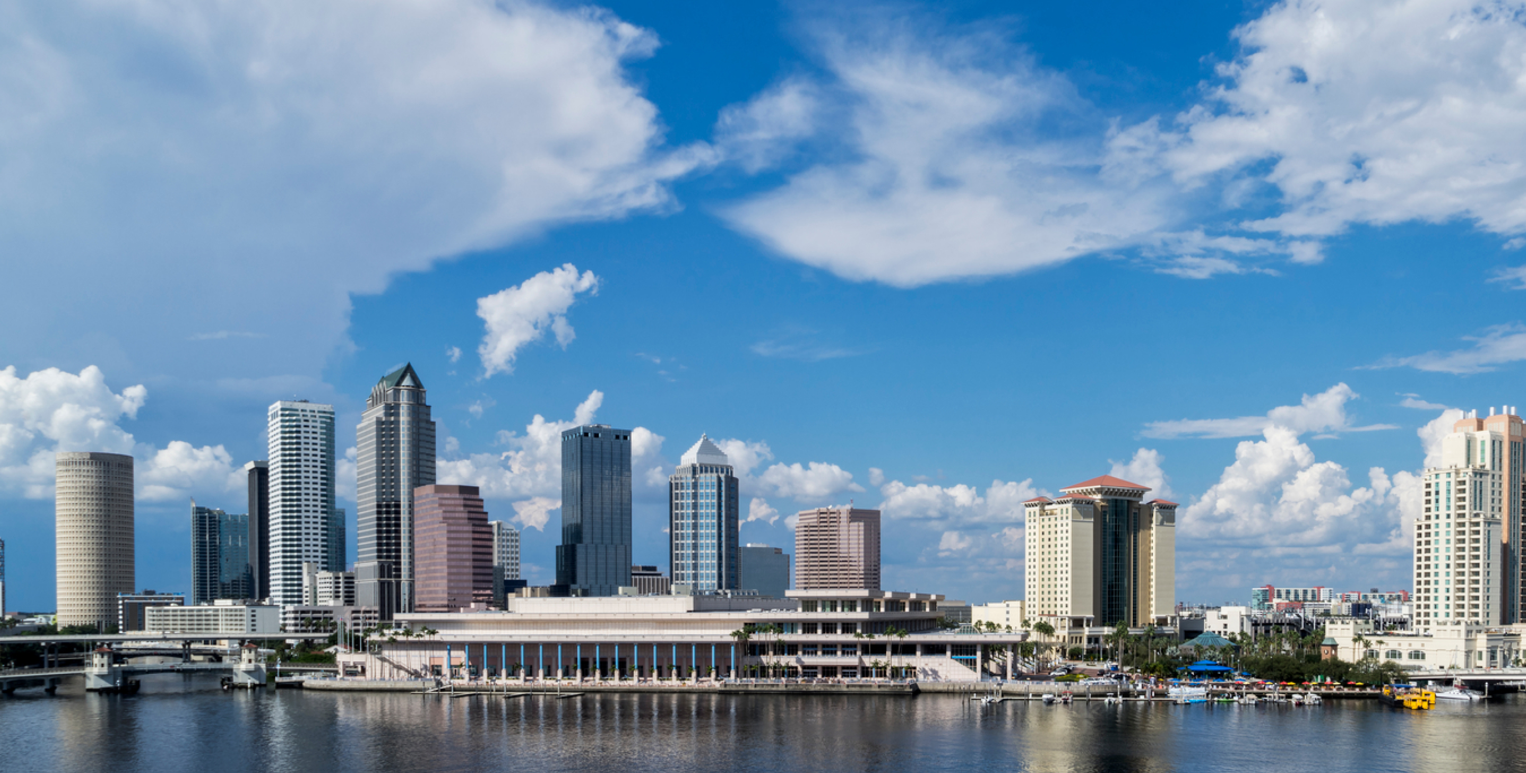 A photo of the city of Tampa with a blue sky and blue ocean