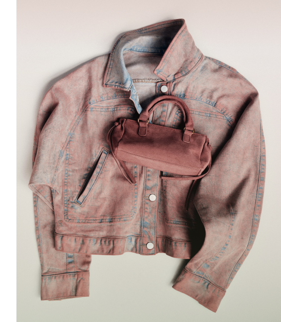 Pink denim jacket with blue stitching laid flat with a small pink leather handbag and sunglasses on top