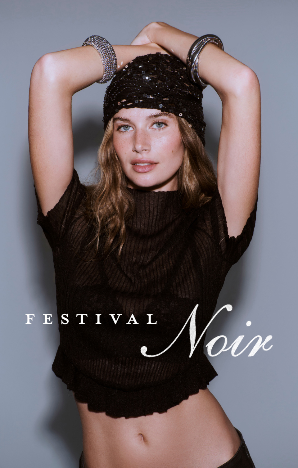 Woman in black sequined beanie and black sweater with silver bracelets. Text reads FESTIVAL Noir.
