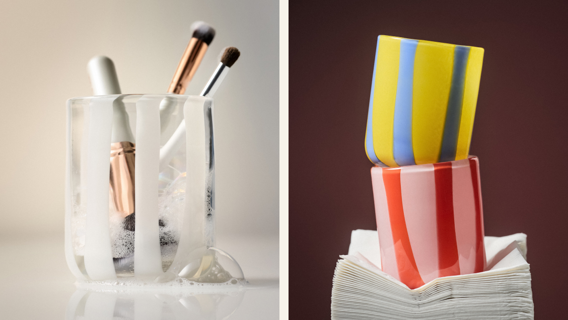 Left: makeup brushes in clear glass holder. Right: yellow and blue striped cup stacked on red cup atop white papers.