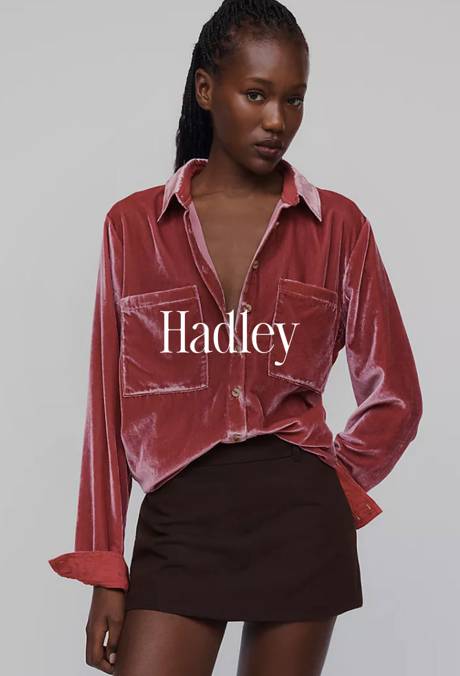 Woman wearing a pink velvet button-up shirt and black skirt with the text Hadley overlaid in white serif font.