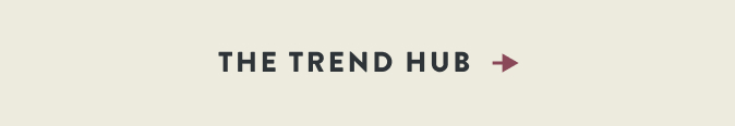 THE TREND HUB text in dark gray with a burgundy arrow pointing right on a beige background