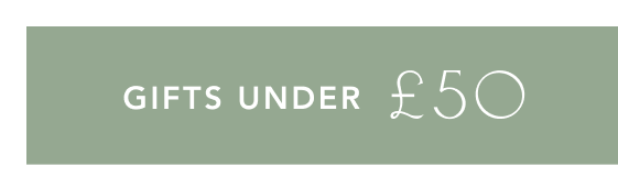Purple banner with white text reading GIFTS UNDER £50 in modern sans-serif font against a solid background.