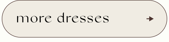 Button with text 'more dresses' in black serif font on beige background with right-pointing arrow