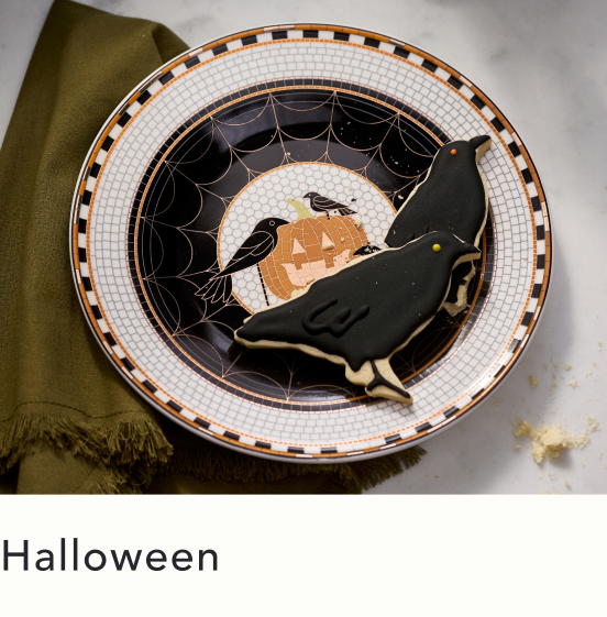 Halloween-themed decorative plate with black cat silhouette, ravens, pumpkin, and spiderweb design on white checkered border with orange accents