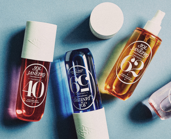 Skincare products arranged on a light blue surface including bottles labeled JANEPRO 40, GG, and SOY ENERGY with a white jar.