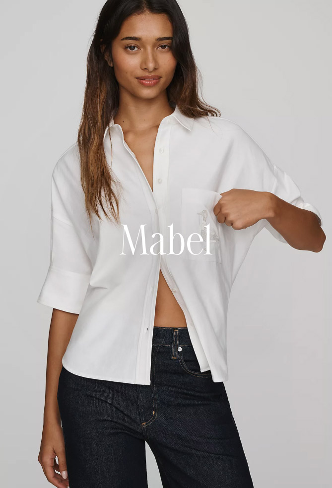 Woman wearing white button-up shirt and dark jeans with text "Mabel" overlaid on center of image.