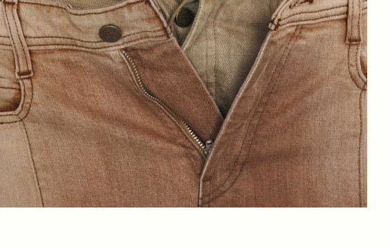 Close-up of faded pink-brown corduroy pants with open zipper and beige waistband showing button closure