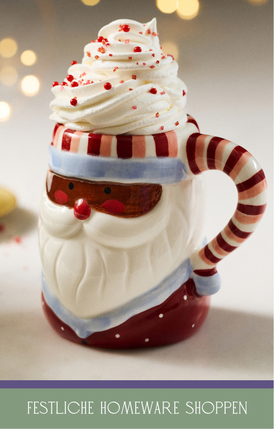 Santa-shaped mug with candy cane handle topped with whipped cream and red sprinkles, with text "SHOP FESTIVE HOMEWARE"