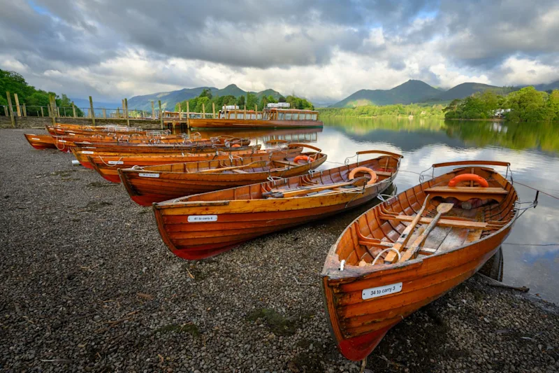 Wooden rowboats on the shores of Derwentwater in Keswick, Lake District, Cumbria, UK