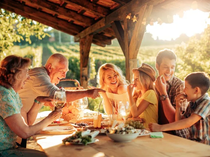 Multigenerational family having a family lunch outdoors on a patio