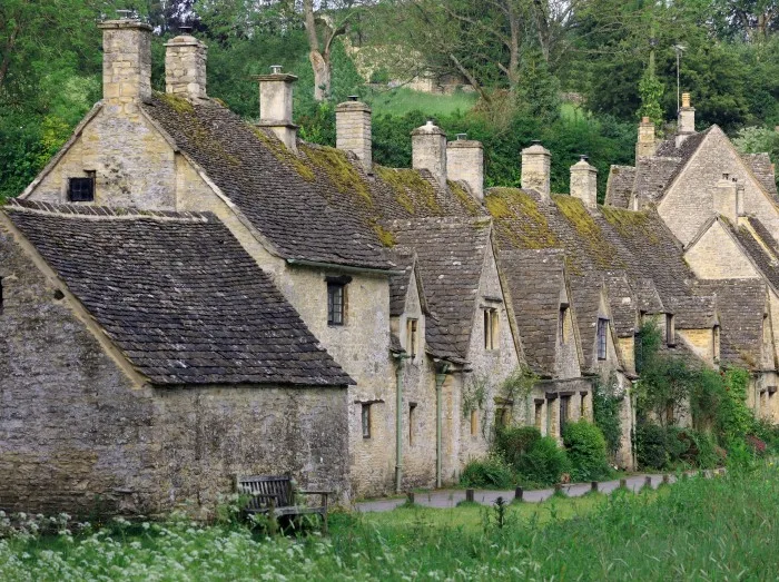 Row Of Old English Stone Cottages Set In The Cotswold Village Of Bibury. Cirencester. UK