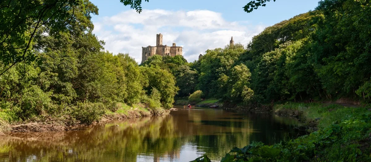 Warkworth Castle and the River Coquet in Morpeth, Northumberland, UK on a sunny day