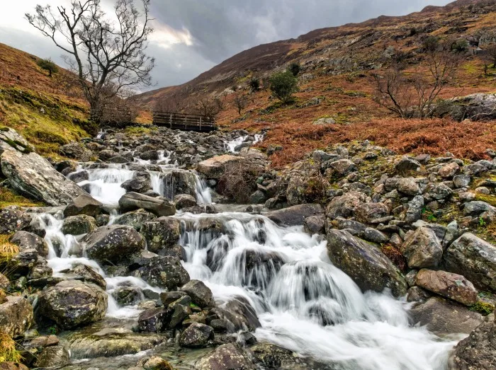 Bridge over Waterfall in Lake District on the path to Castle Cragg