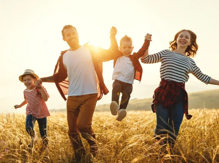 Happy family father of mother and child son on nature at sunset