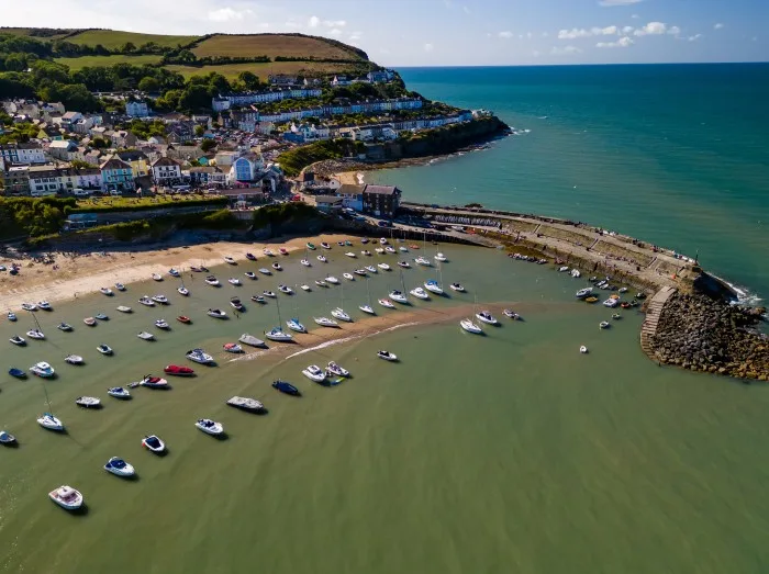 Aerial view of boats and the beach at the colorful Welsh seaside town of New Quay in Cardigan Bay