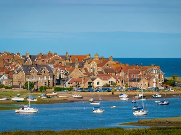 Sailboats moored in the estuary by the charming coastal village of Alnmouth