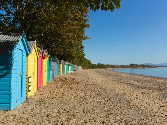 Colourful beach huts Llanbedrog beach Llyn peninsula Wales between Pwllheli and Abersoch