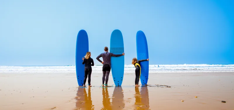 Family surfing at the beach